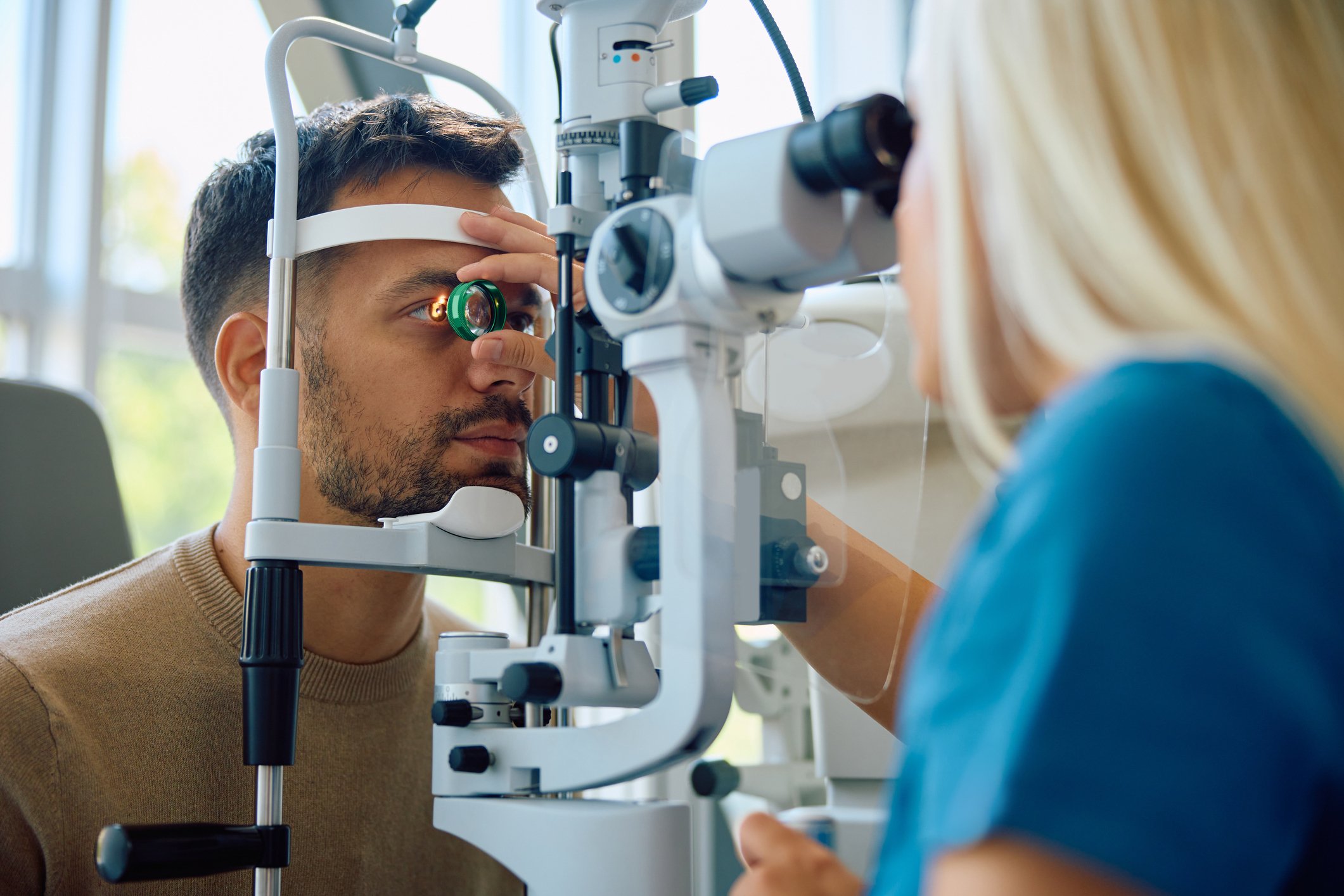 Ophthalmologist examining a patient’s eye using a slit lamp during a clinic visit.
