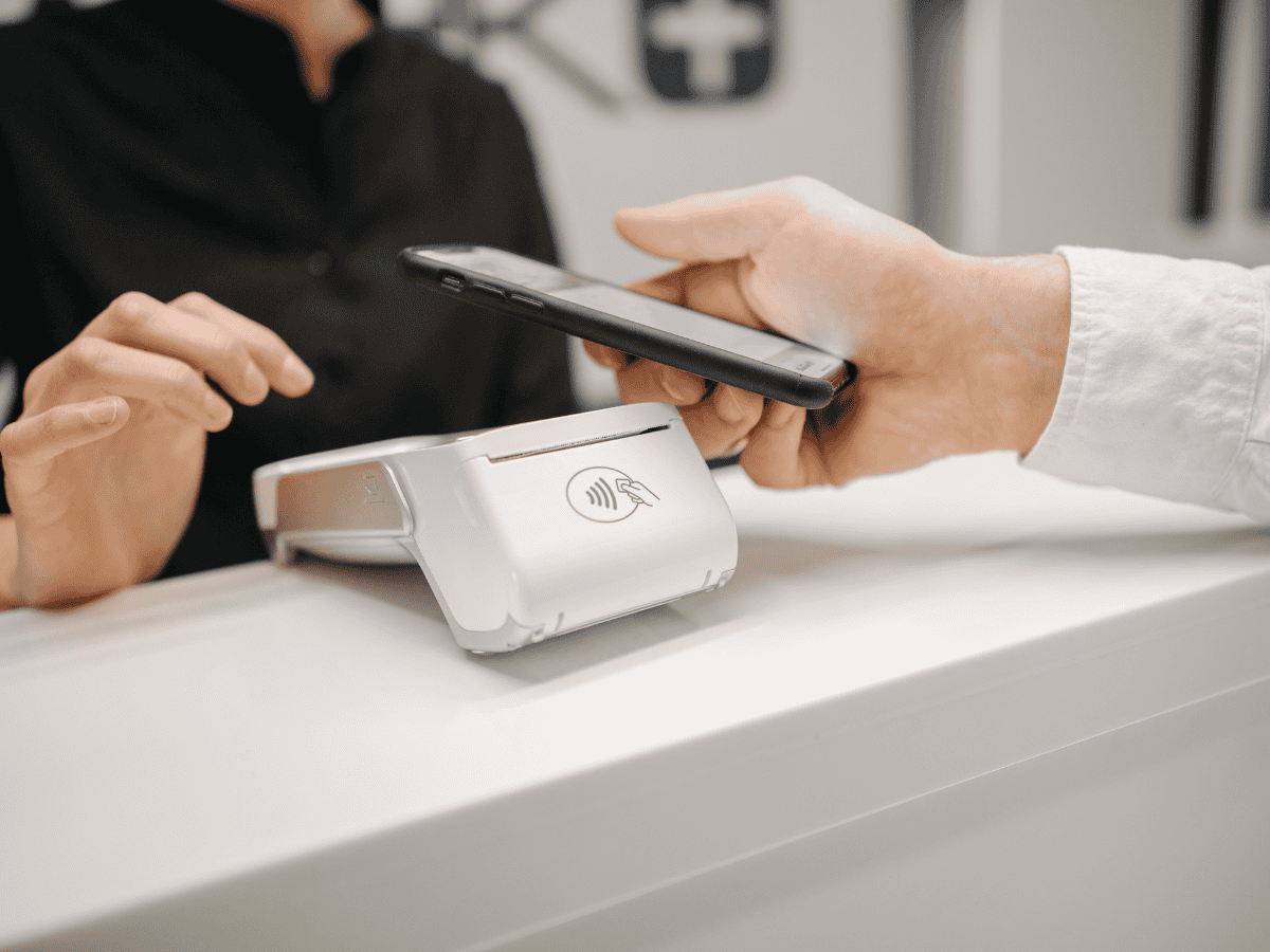 Patient at the eye doctor using tap to pay for payment