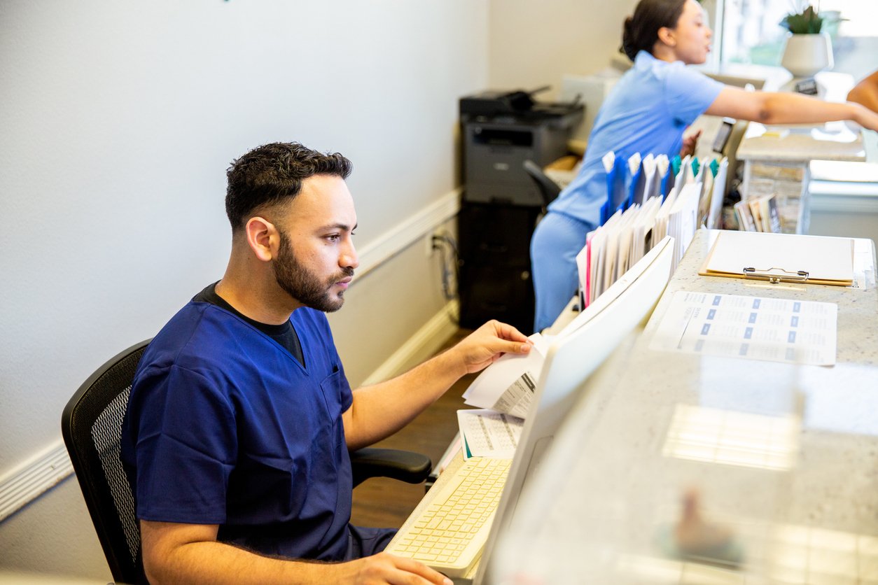 Ophthalmology billing staff reviewing claims at the front desk