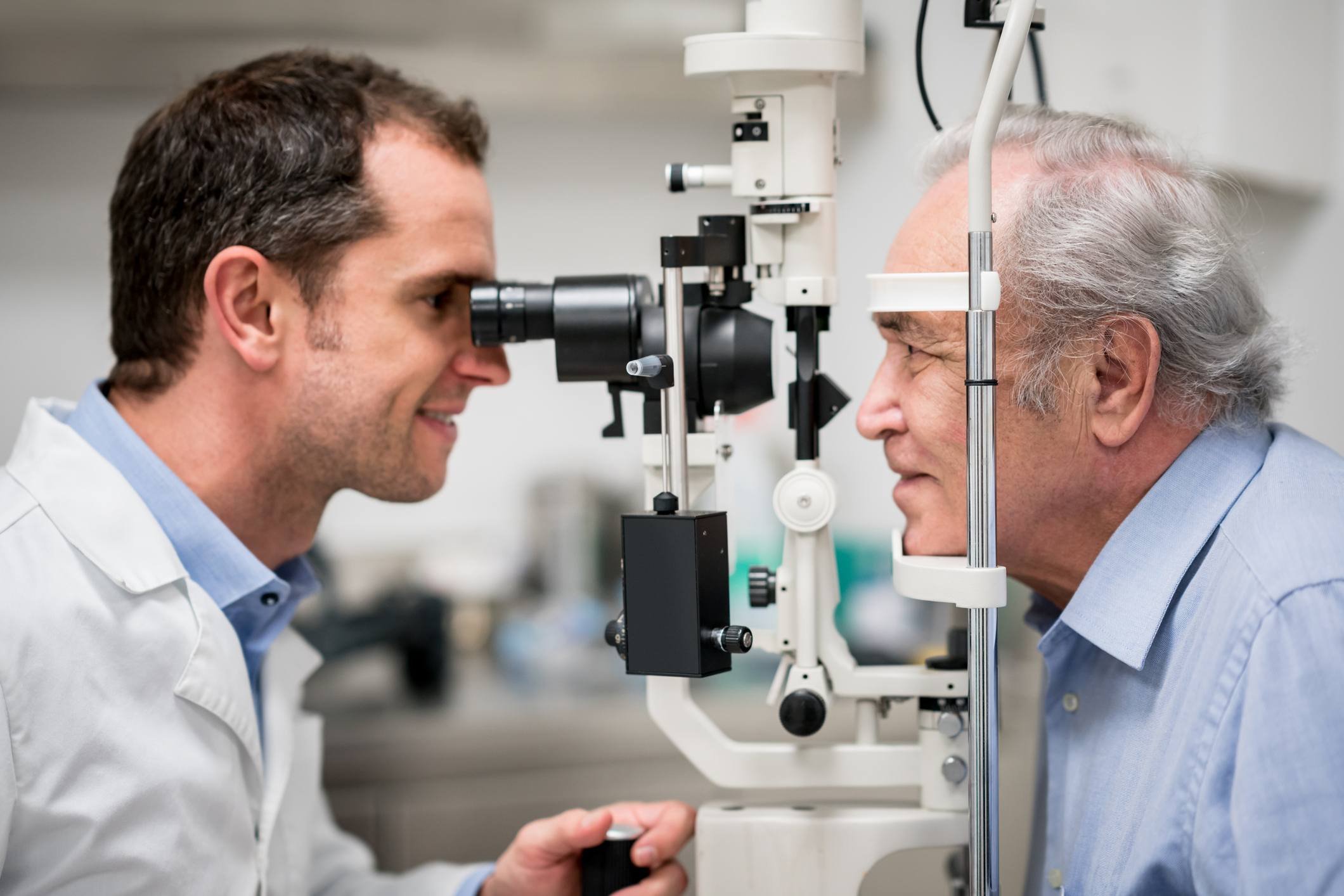 Ophthalmologist performing eye exam on patient