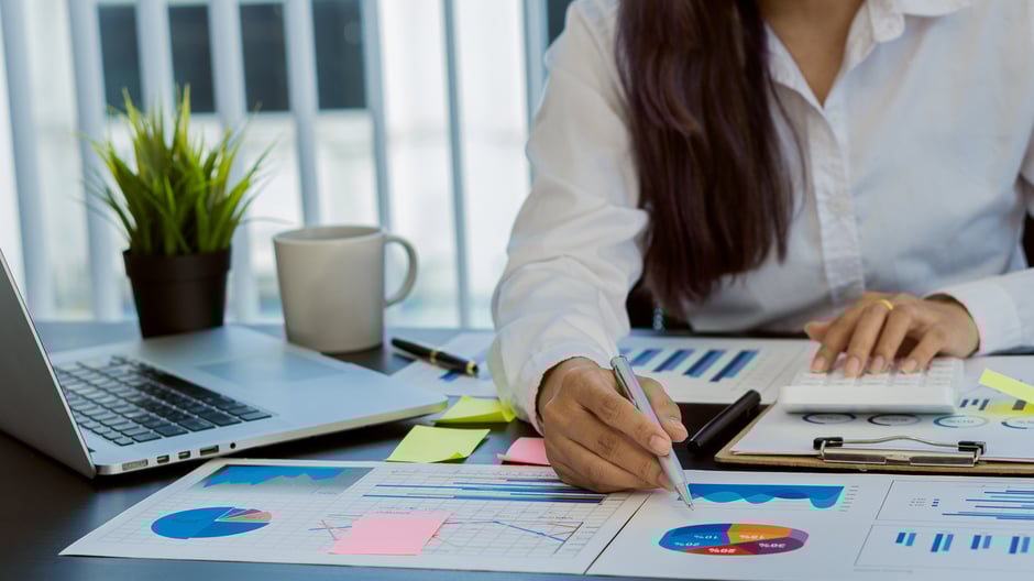 Outsourced billing specialist evaluating reports, demonstrating outsourcing RCM as an eye care trend.