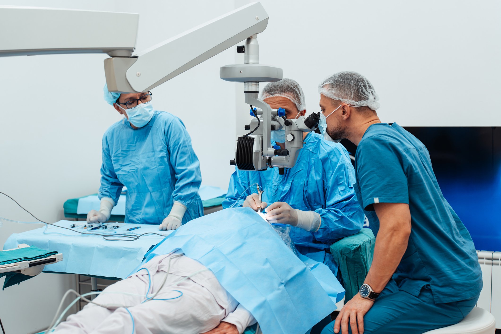 Ophthalmology surgical team performing an eye procedure in an operating room