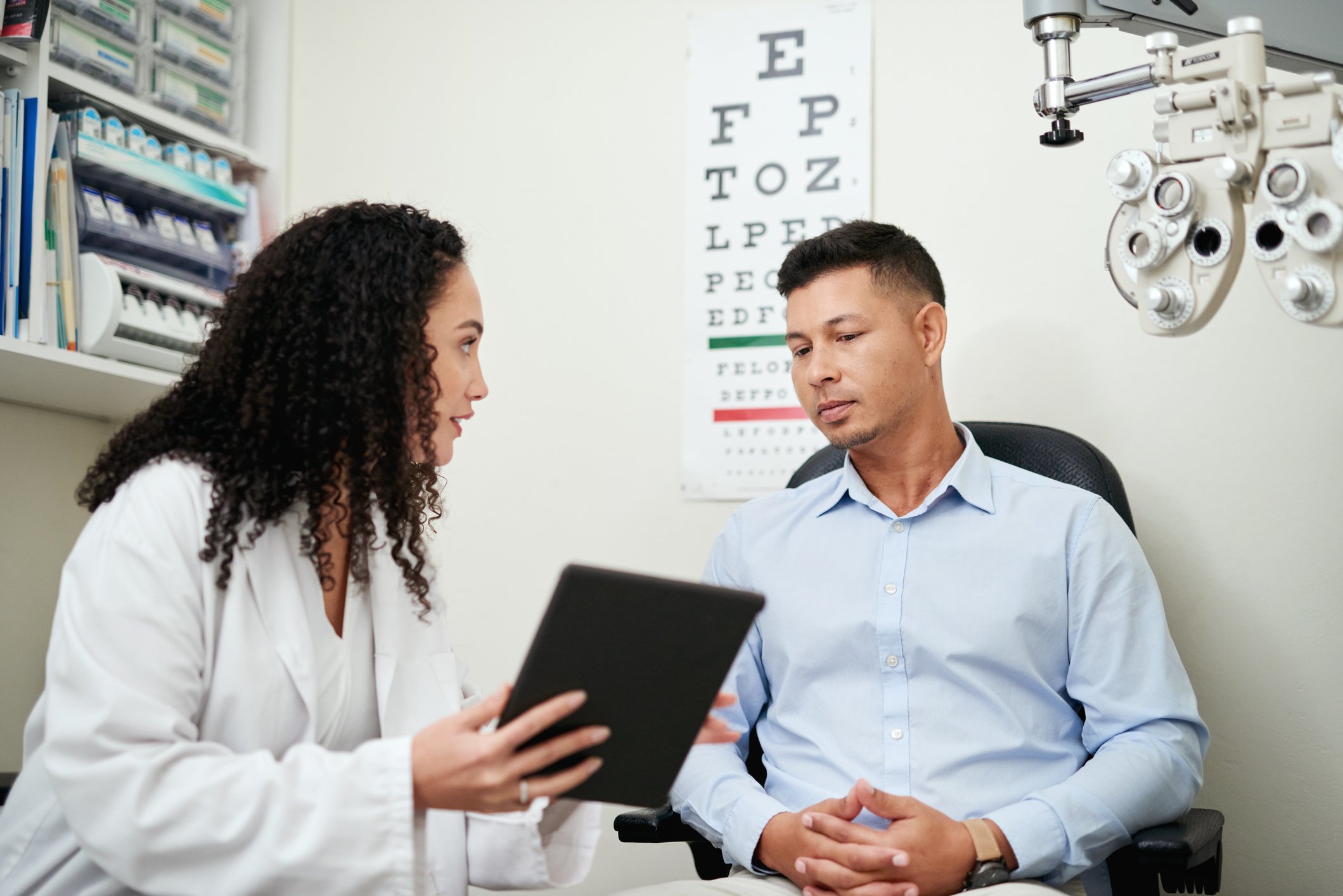 Ophthalmology provider reviewing treatment information with a patient, supporting patient education.