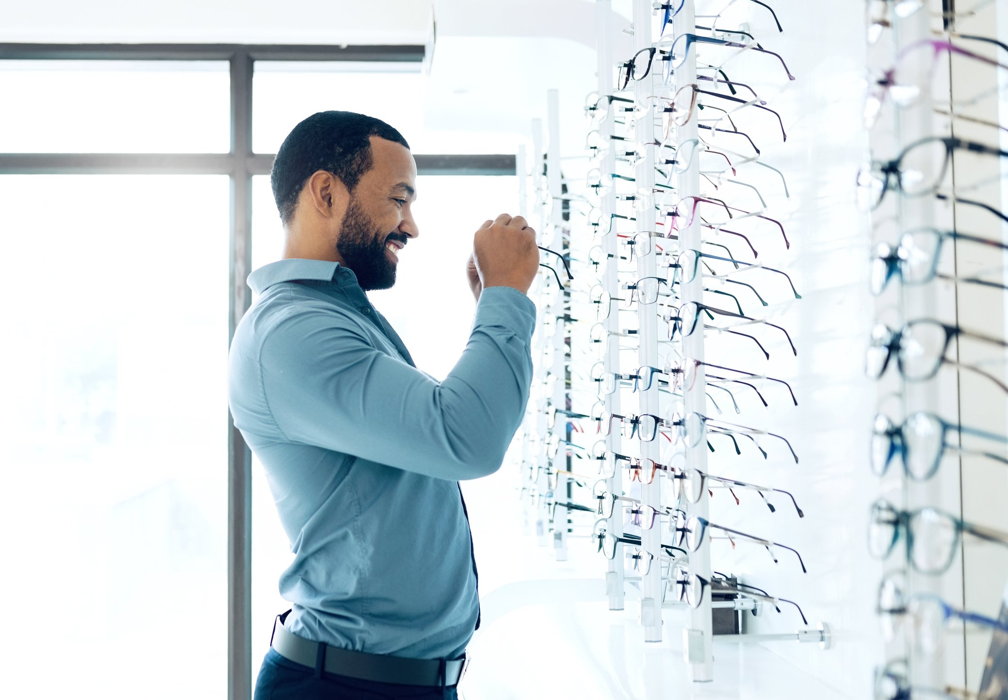Man browsing frames in an optical shop
