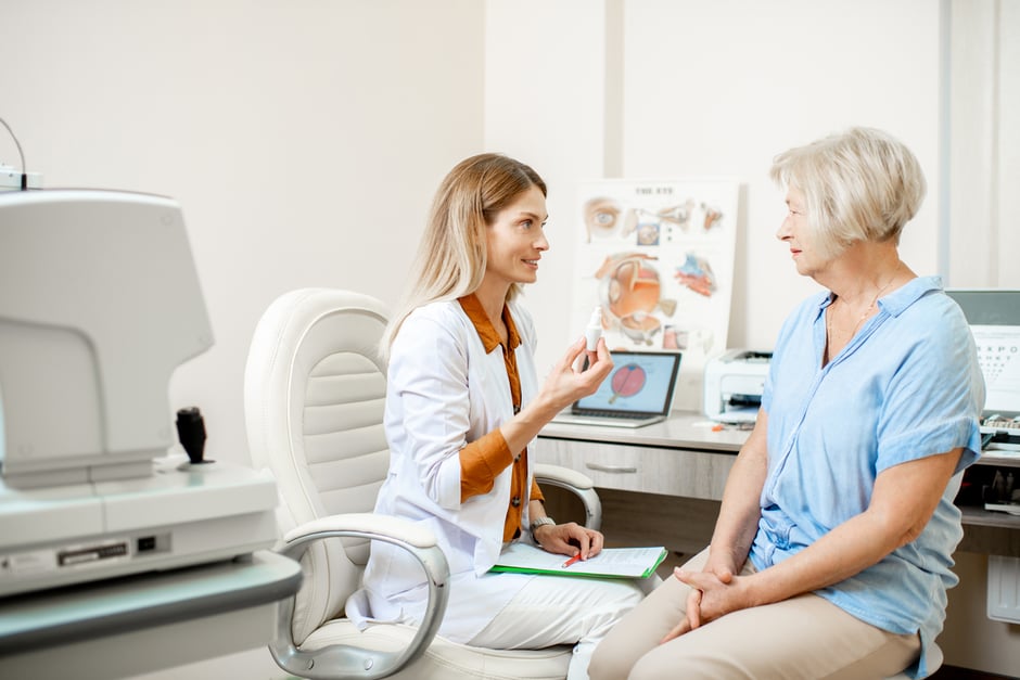 Elderly female patient learning about eye care from her optometry provider.