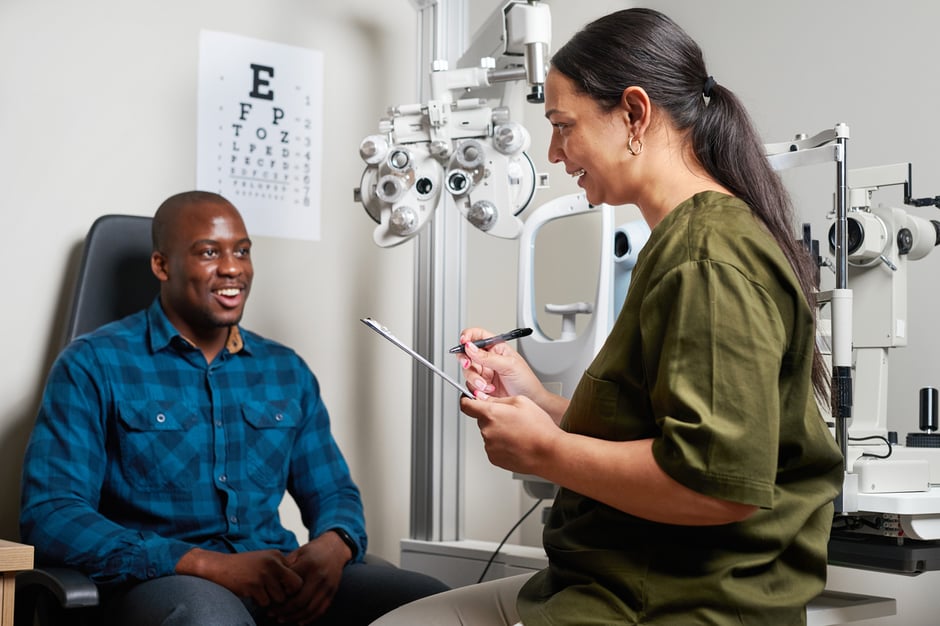 Ophthalmologist discussing treatment with a patient as part of quality care and MIPS reporting in ophthalmology.