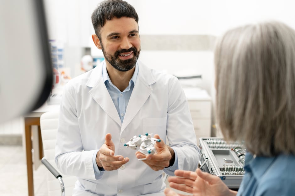 Ophthalmologist showing progressive lenses to a senior patient in an ophthalmology clinic.