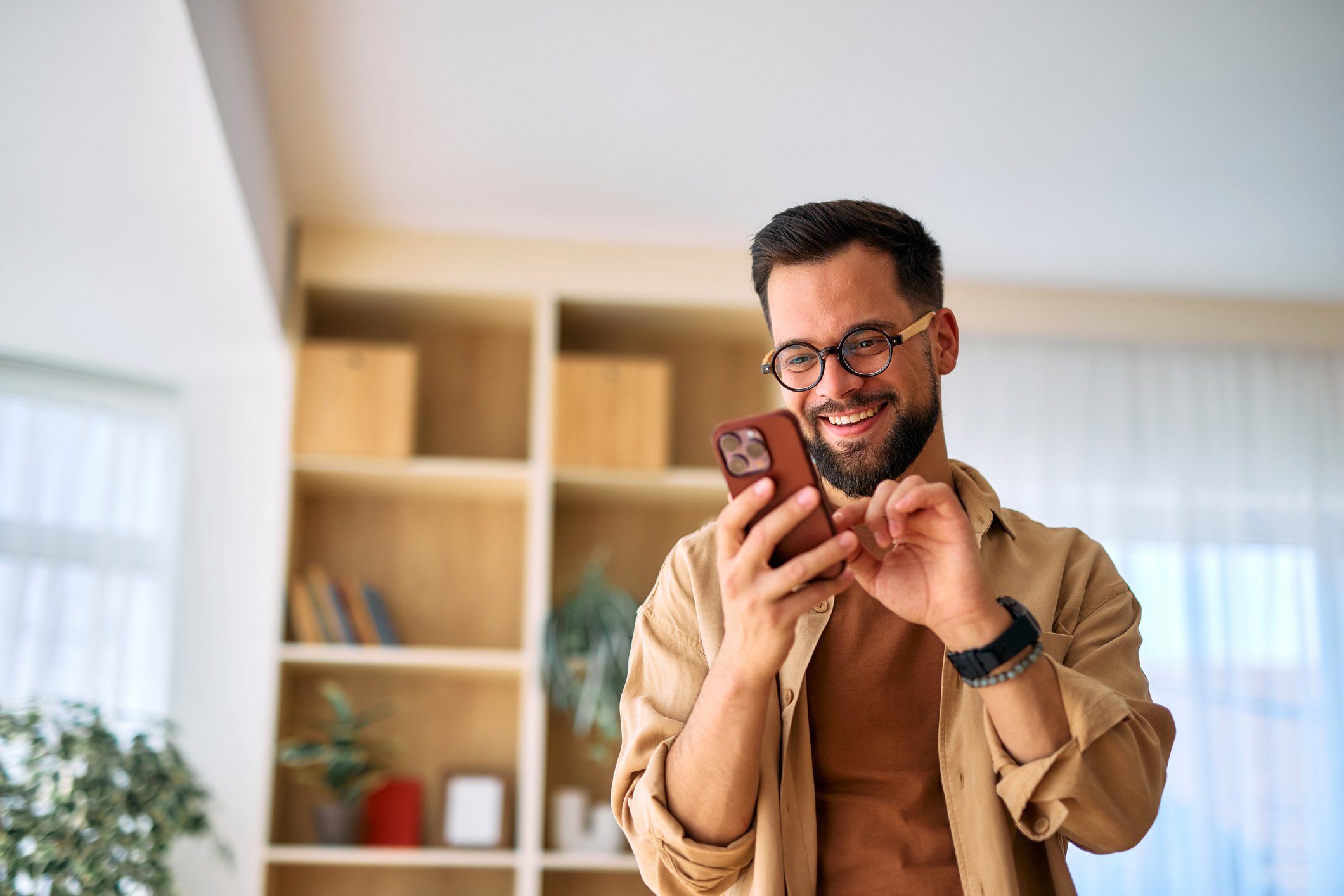 Patient checking an appointment reminder on his phone for an ophthalmology visit.