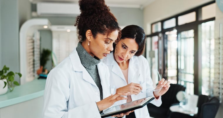 Tablet, women and optician in store for vision discussion, planning treatment or eyesight test results. Digital technology, optometrist and ophthalmology with glasses for eye health with medical team