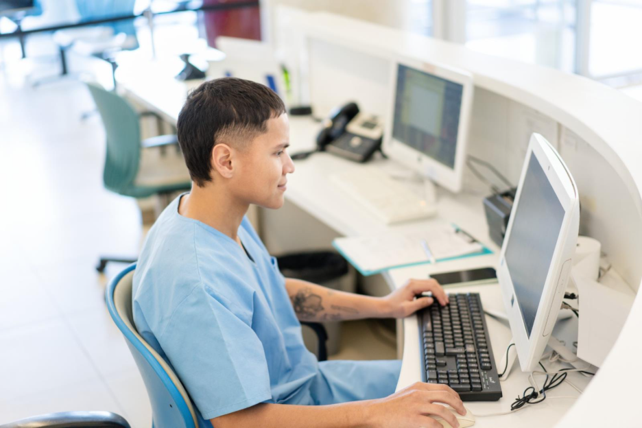 Clinic staff member reviewing MIPS data in an ophthalmology EHR.